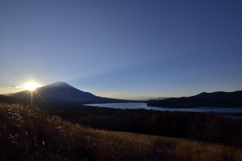 夕暮れの富士山と山中湖| 富士山の稜線に太陽が沈んでいきます