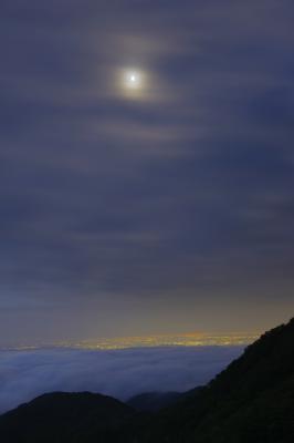 雲海の先には関東平野の大夜景が広がっています。上空には月が輝いていました。